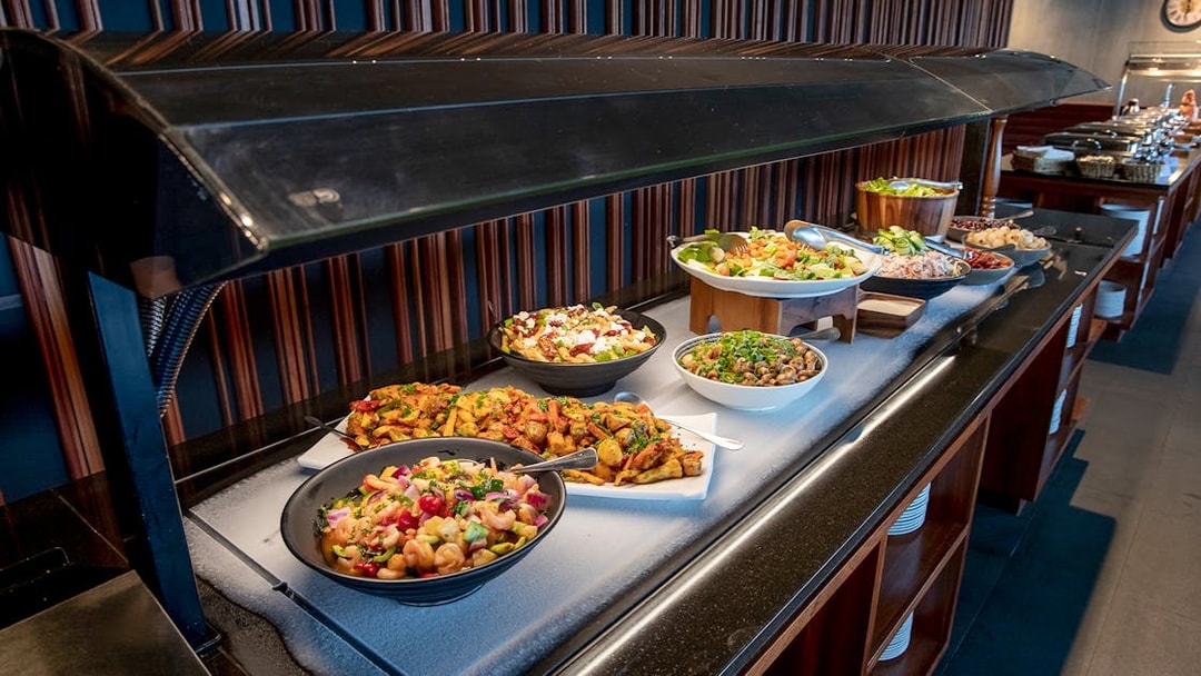 Buffet setup at Te Puia geothermal park featuring traditional Hāngī dishes.