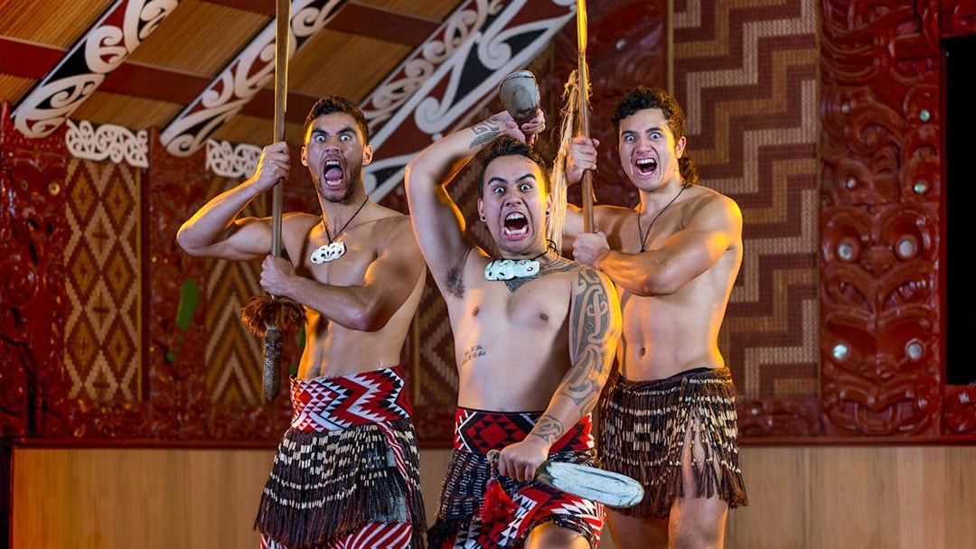 Maori performers in traditional attire during a haka at Te Puia, New Zealand.