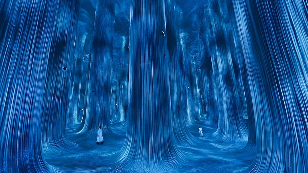 Immersive digital art installation at TeamLab Phenomena Abu Dhabi with flowing blue lights.