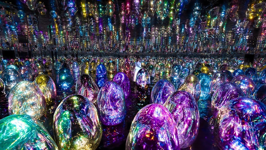 Colorful illuminated orbs in TeamLab Phenomena Abu Dhabi exhibit.