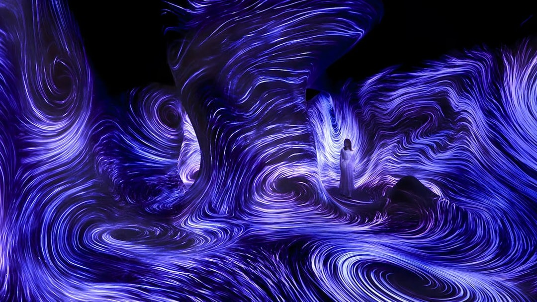 Immersive light installation at TeamLab Phenomena Abu Dhabi with swirling blue patterns.