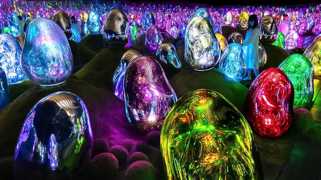 Colorful digital art installations at TeamLab Planets Tokyo with illuminated sculptures.
