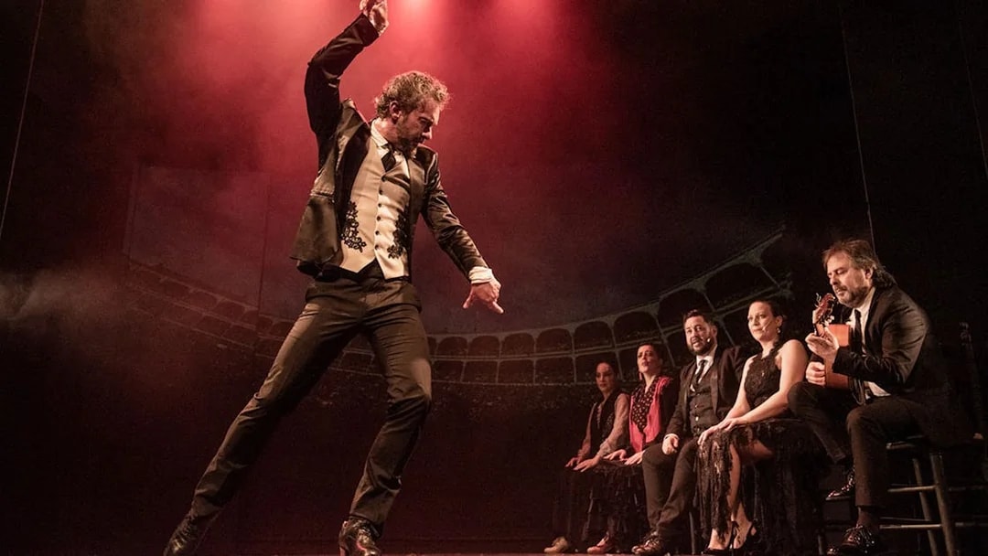 Flamenco dancer performing on stage with musicians at Teatro Flamenco Barcelona.
