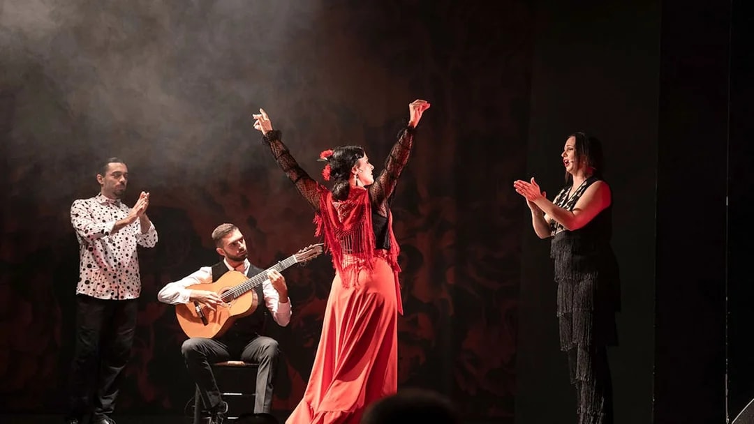 Flamenco dancer performing with musicians at Teatro Flamenco Barcelona.