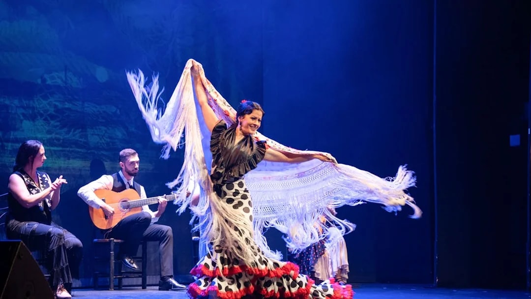Flamenco dancer performing with musicians at Teatro Flamenco Barcelona.