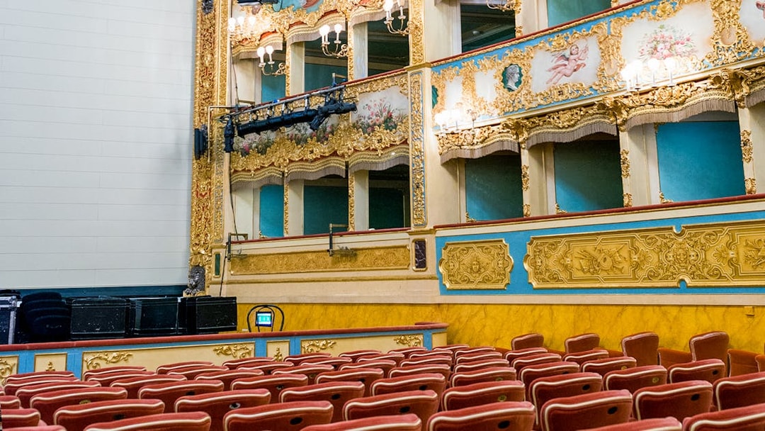 Teatro La Fenice auditorium with ornate balconies and red seats, Venice.