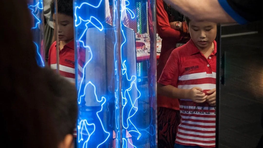 Child observing interactive exhibit at Tech Dome Penang.