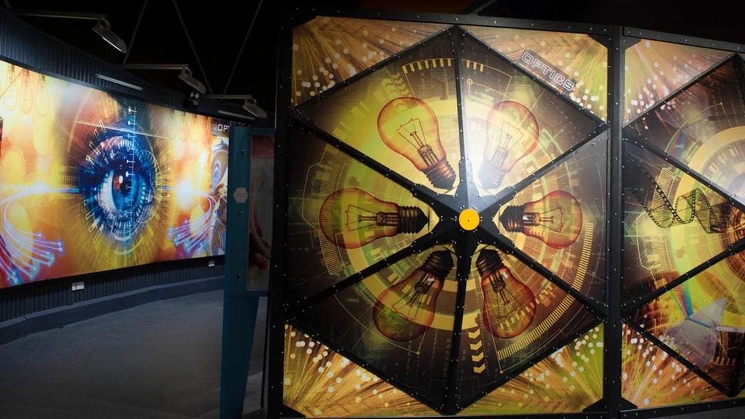Interactive exhibit with light bulb and eye graphics at Tech Dome Penang.