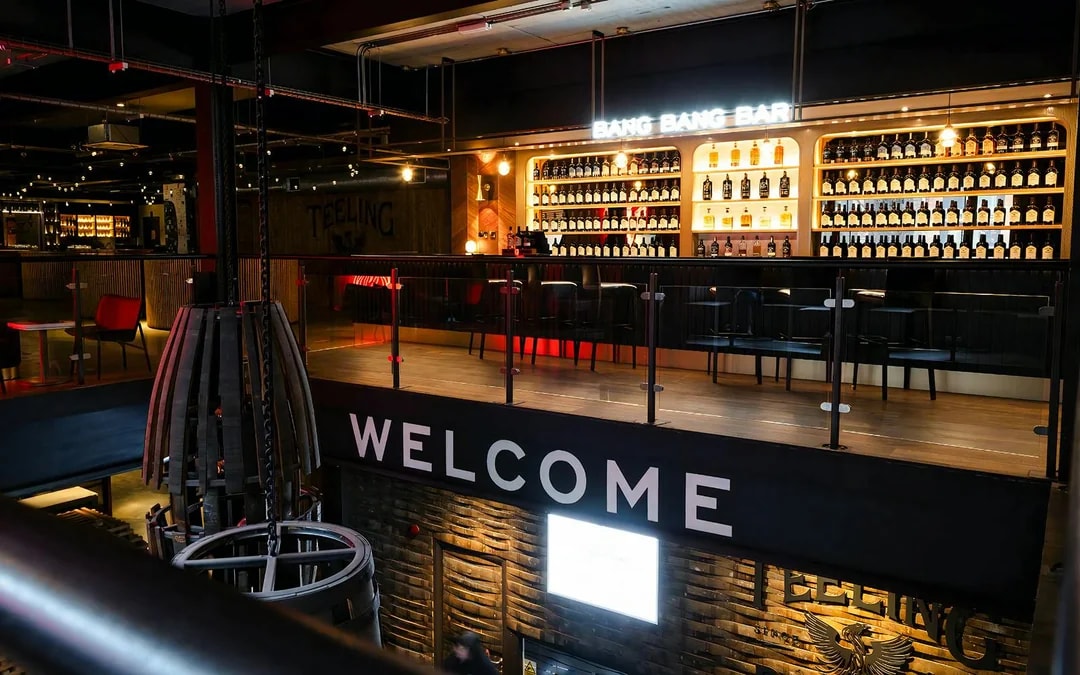 Bar area at Teeling Distillery with bottles displayed on shelves, Dublin, Ireland.