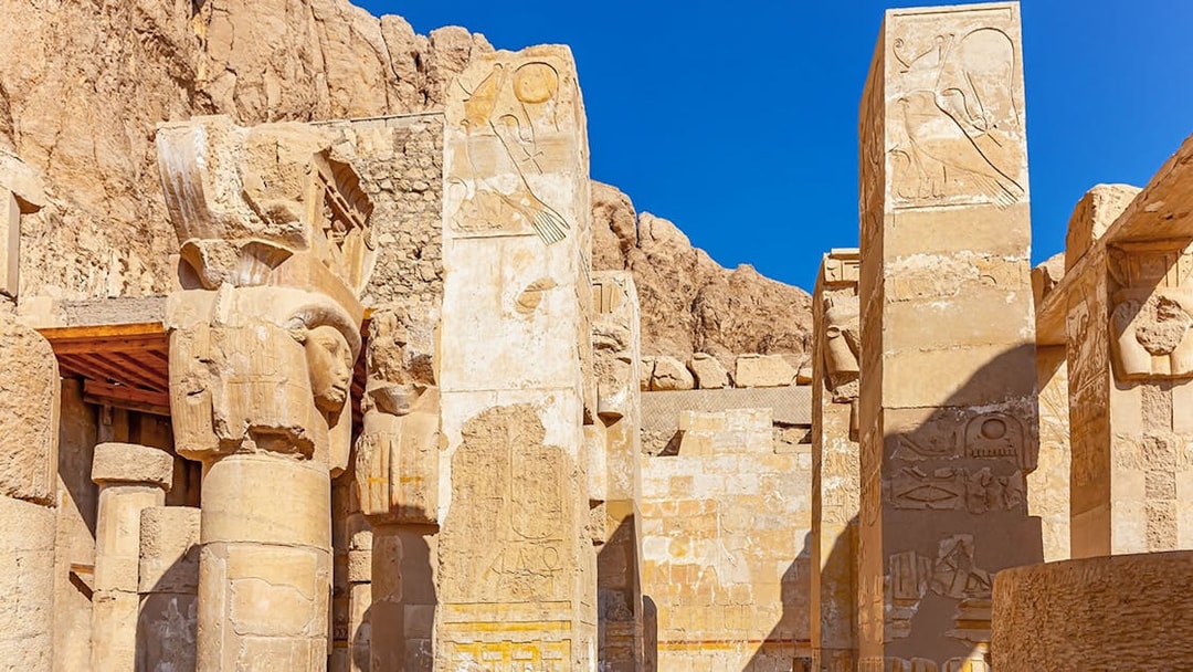 Hathor capital columns at Mortuary Temple of Hatshepsut, Luxor, Egypt, with hieroglyphs.