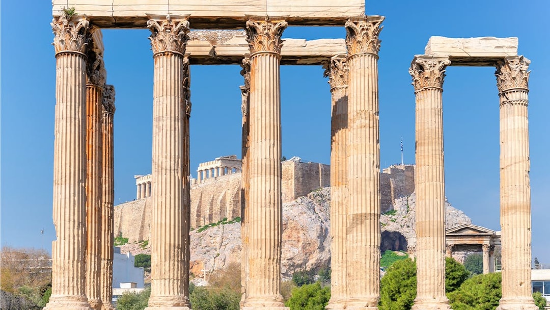 Temple of Olympian Zeus columns with Acropolis in background, Athens, Greece.