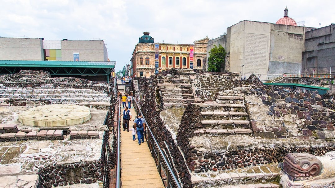 Visitors walking through Templo Mayor ruins in Mexico City.
