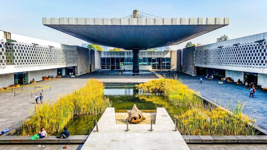 Anthropology museum entrance with courtyard pond and unique roof structure.