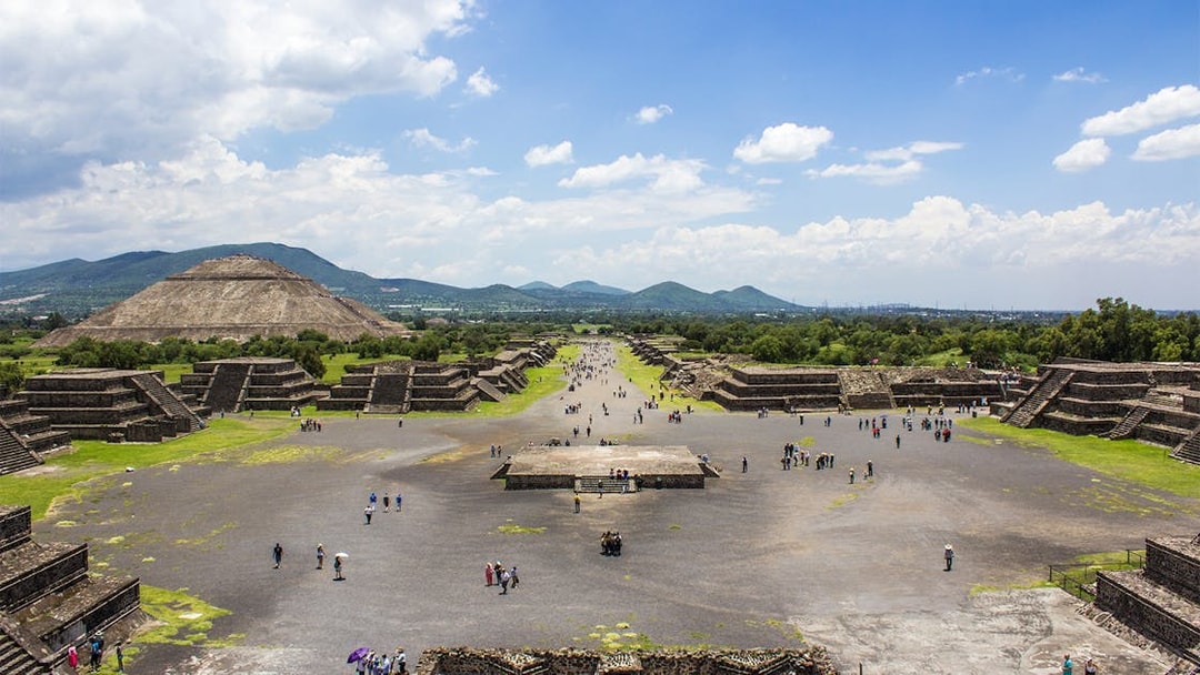 Teotihuacan pyramids and Avenue of the Dead, Mexico City, with visitors exploring.