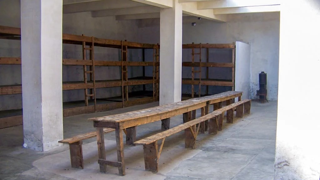 Wooden bunks and benches inside Terezin Concentration Camp barracks, Czech Republic.