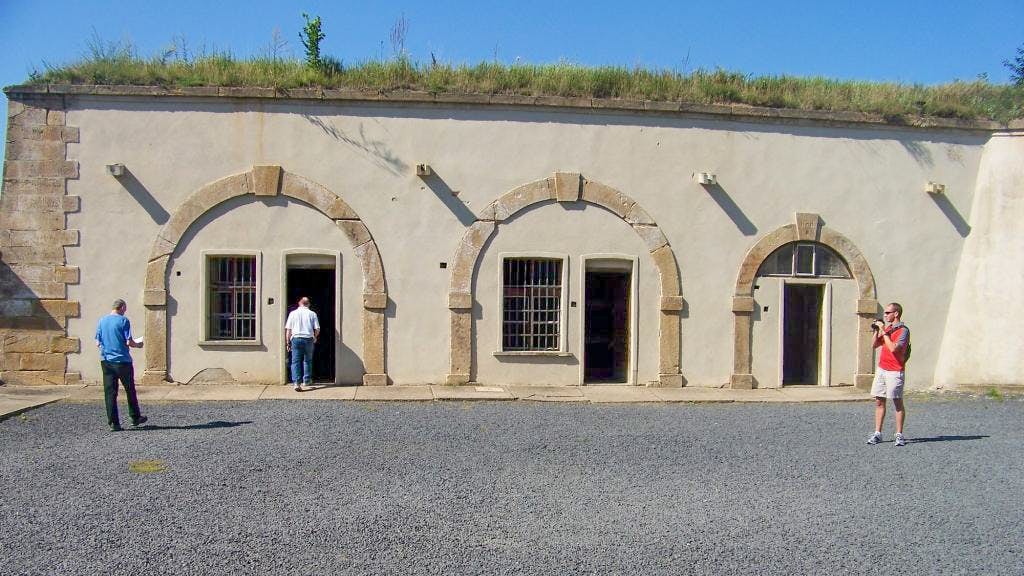 Visitors exploring Terezin Concentration Camp building on a tour from Prague.