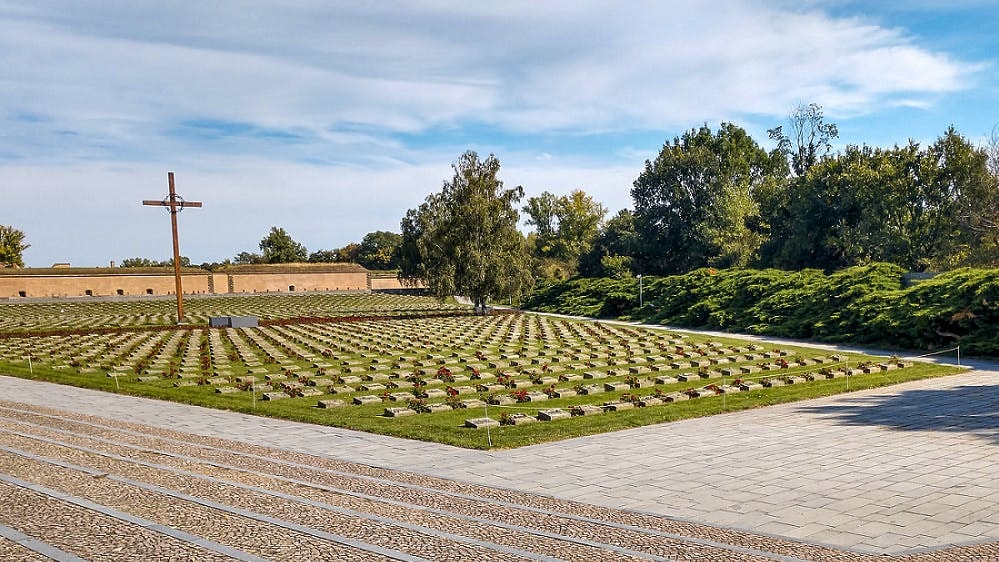 Terezin Concentration Camp cemetery with cross and rows of graves, Czech Republic.