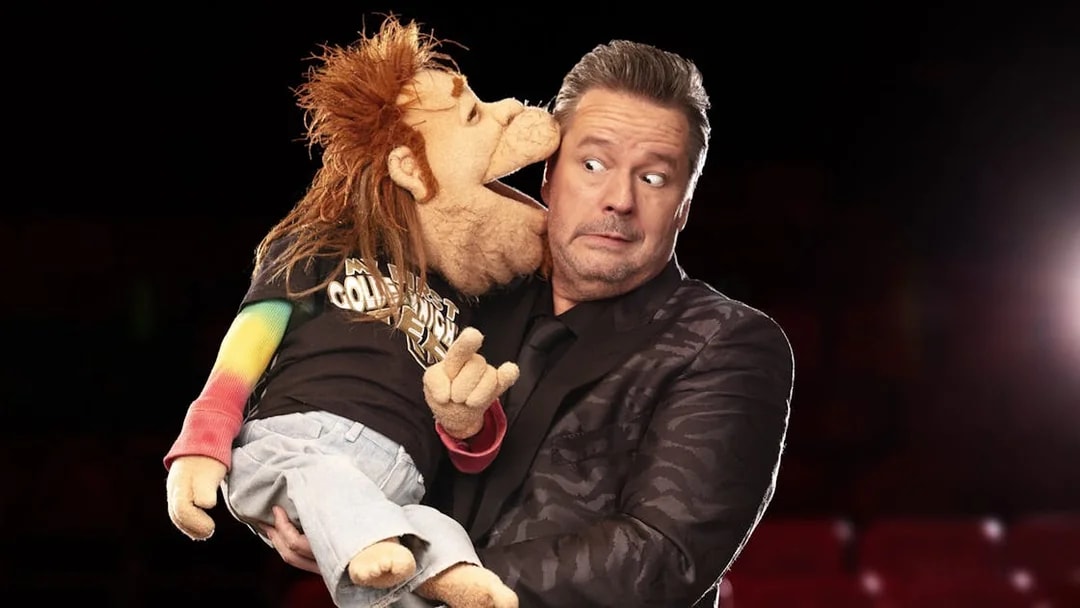 Ventriloquist with puppet on stage, part of "Terry Fator: One Man, a Hundred Voices, a Thousand Laughs!" show.