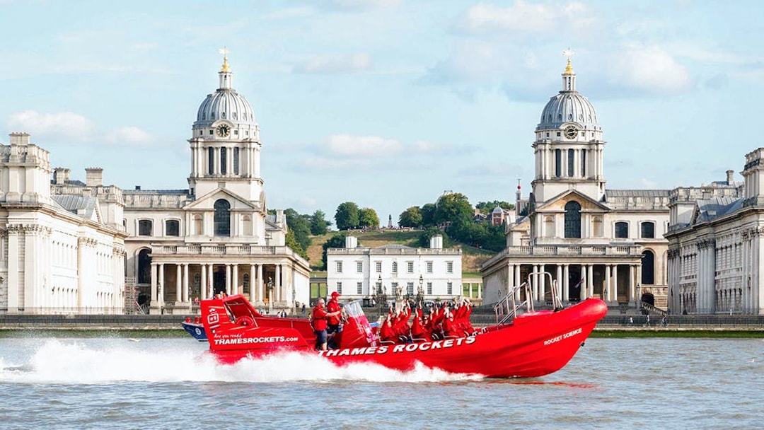Thames speed boat passing by the Old Royal Naval College in London.