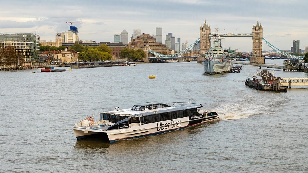 Uber Boat on Thames River near Tower Bridge, London.
