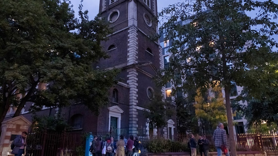 Tour group outside historic church on Jack the Ripper Tour in London.