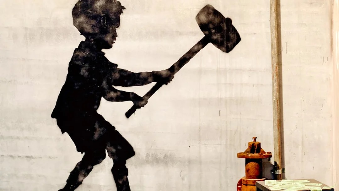 Silhouette of a child with a sledgehammer at the Banksy Museum.