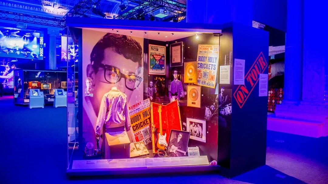 Buddy Holly exhibit at the British Music Experience, featuring memorabilia and posters.