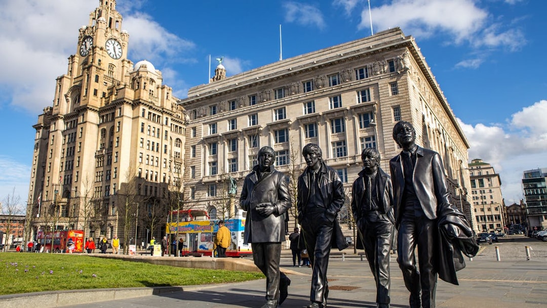 Statues of four musicians in front of the Royal Liver Building, Liverpool.