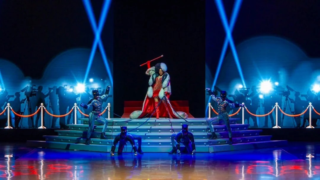 Performers on stage at The Colosseum Show with dramatic lighting and costumes.