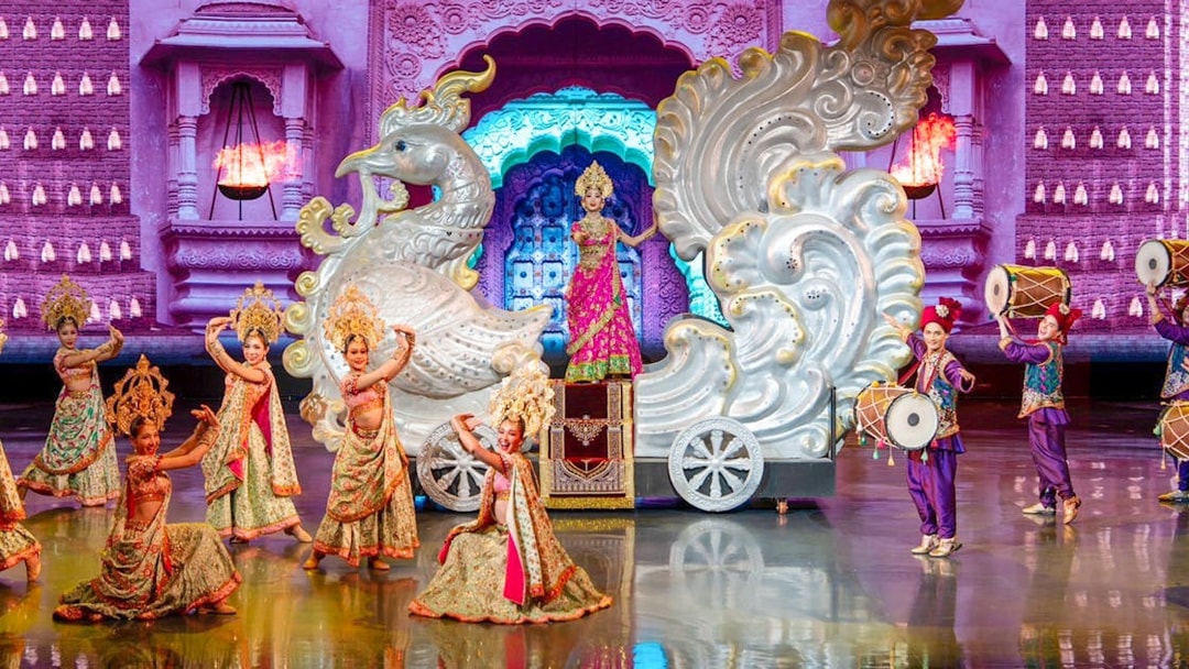 Performers in traditional costumes on stage at Colosseum Cabaret Show Pattaya.