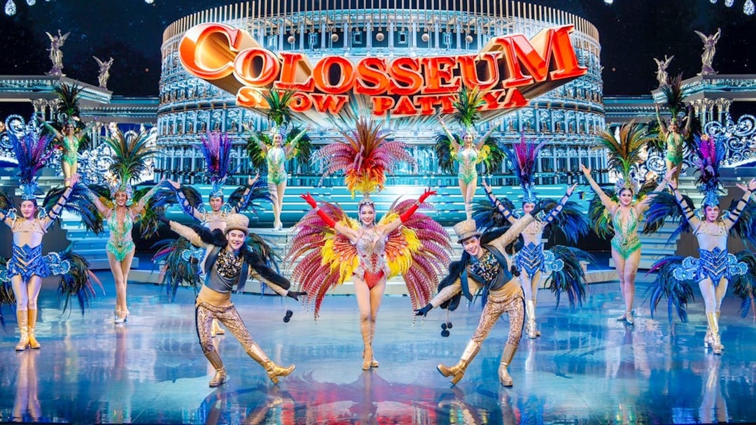 Performers in vibrant costumes on stage at Colosseum Cabaret Show Pattaya.