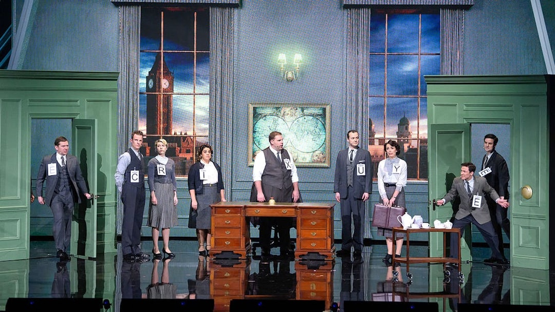 Actors on stage in a comedic spy play set in London, featuring Big Ben in the background.