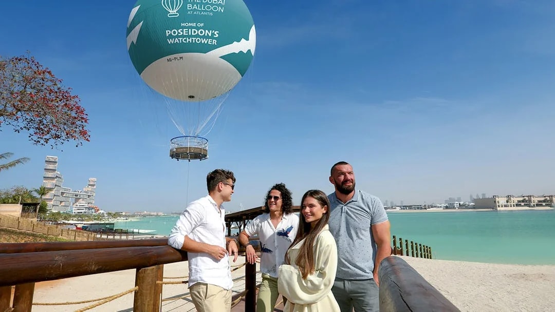 The Dubai Balloon at Atlantis with tourists enjoying the view by the waterfront.