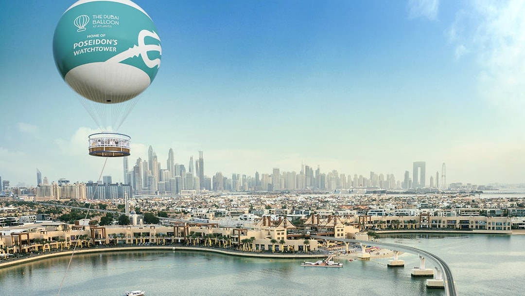 Dubai skyline with The Dubai Balloon at Atlantis floating above Palm Jumeirah.