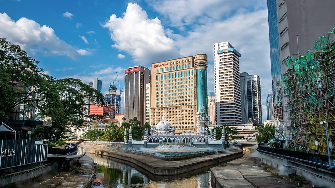Kuala Lumpur skyline with Jamek Mosque and modern skyscrapers on the Great KL City Tour.