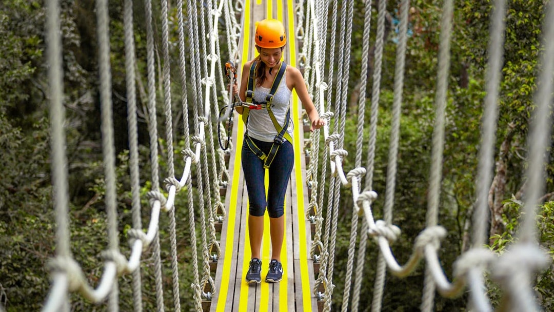 Person crossing a rope bridge at Habitat Penang Hill.