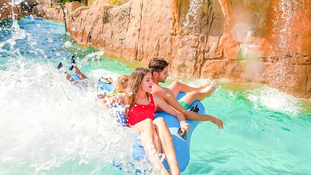 People enjoying a wild river ride at The Land of Legends water park.