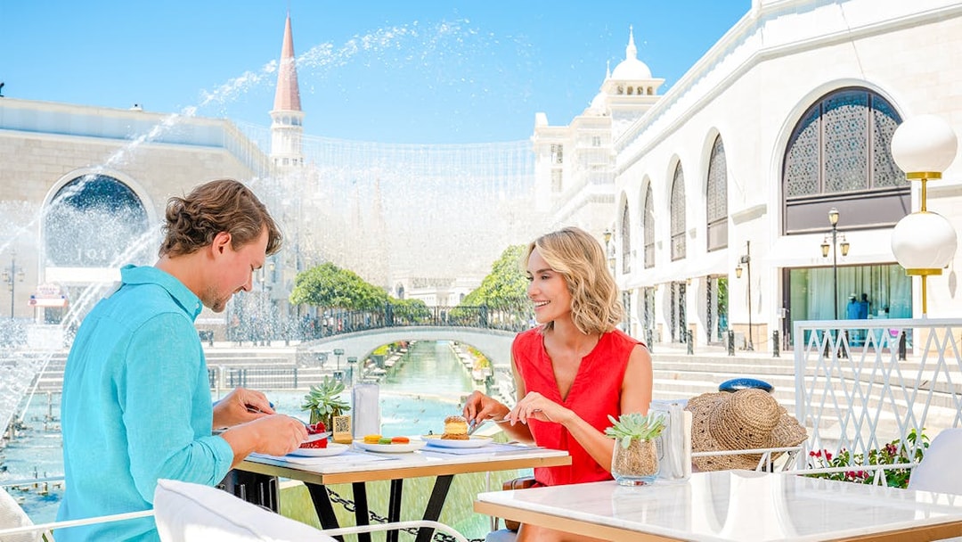 Lunch at The Land of Legends theme park with a view of fountains and architecture.
