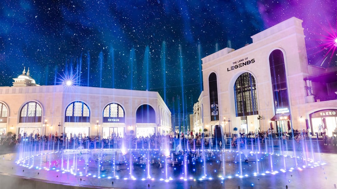 Water fountain illuminated at night, The Land of Legends theme park.