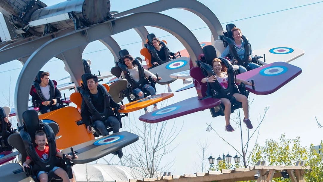 Visitors enjoying a flying ride at Land of Legends Theme Park, Antalya.
