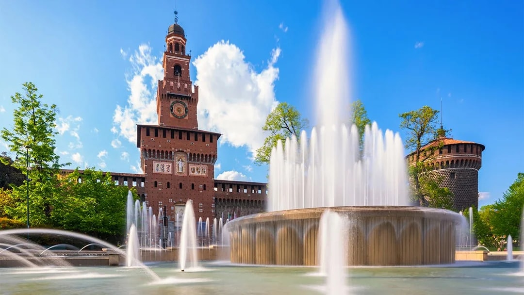 Fountain at Piazza Castello with Sforza Castle in Milan, Italy.