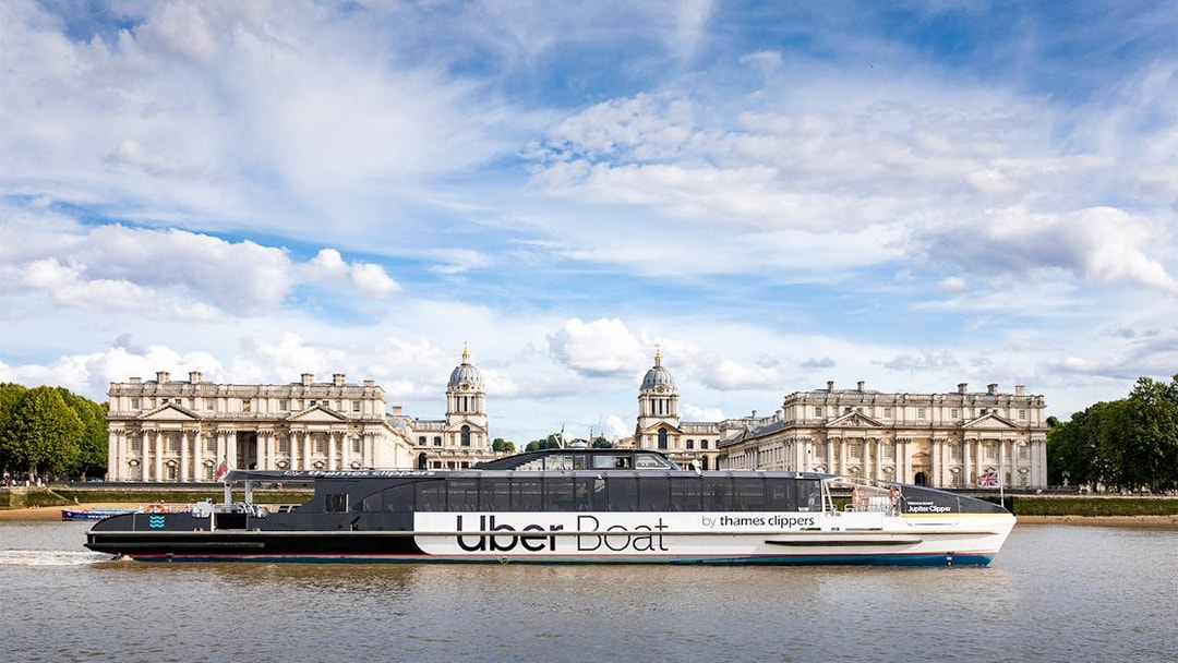 Uber Boat cruising past the Old Royal Naval College in London.