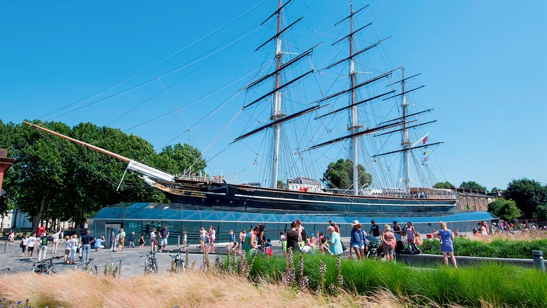 Cutty Sark ship at National Maritime Museum, London, with visitors nearby.