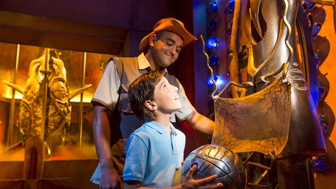 Child exploring interactive exhibit at The Lost Chambers Aquarium.