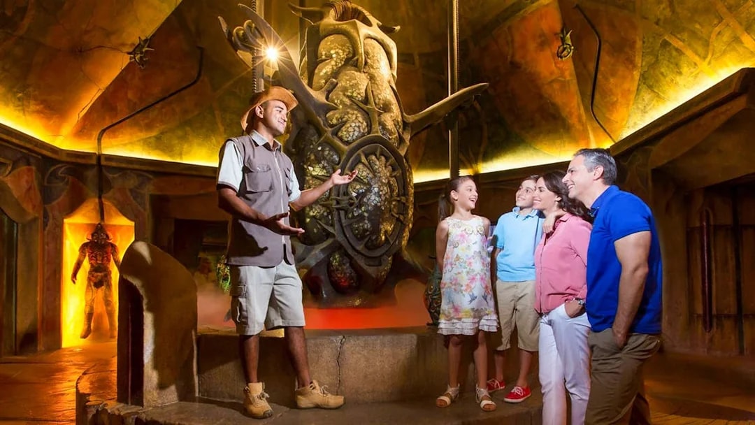 Guide explaining exhibit to family at The Lost Chambers Aquarium.