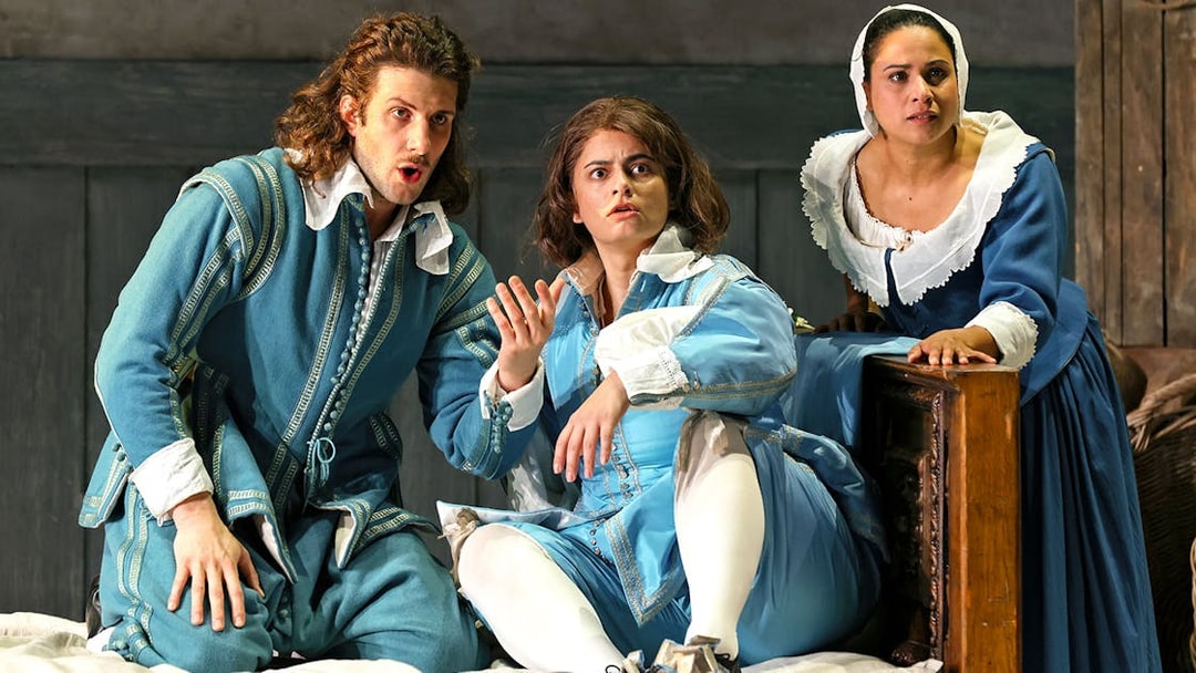 Opera performers in period costumes during a scene from The Marriage of Figaro.
