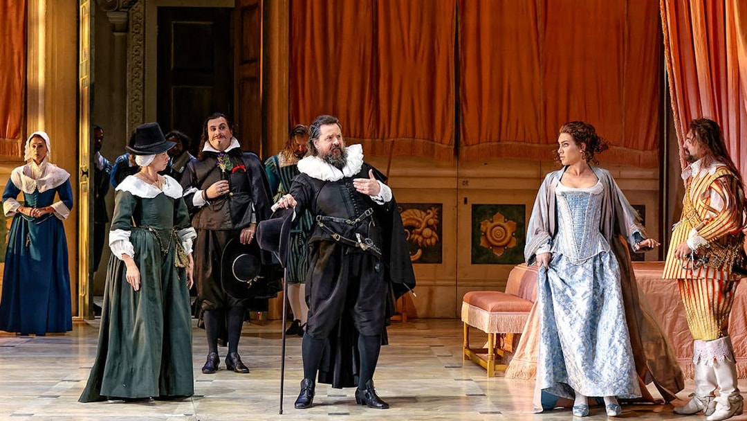 Actors in period costumes perform a scene from "The Marriage of Figaro" on stage.