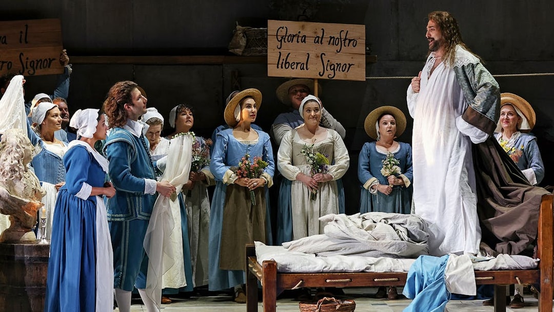 Opera scene from The Marriage of Figaro with performers in period costumes on stage.