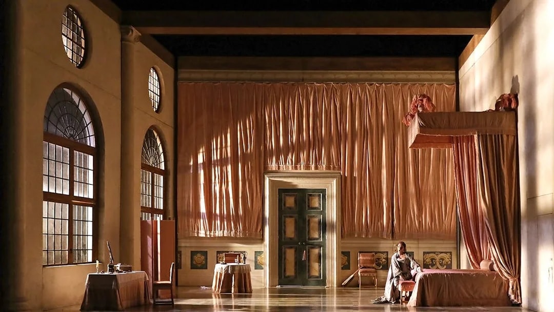 Opera stage set for "The Marriage of Figaro" with elegant drapery and period furniture.