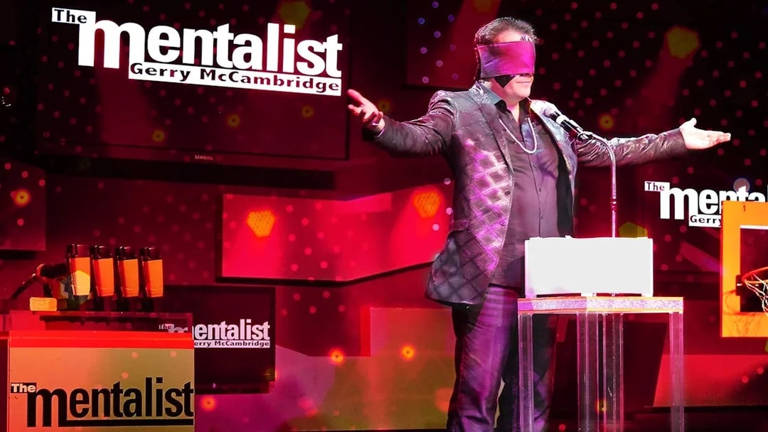 Performer on stage with blindfold during The Mentalist show.